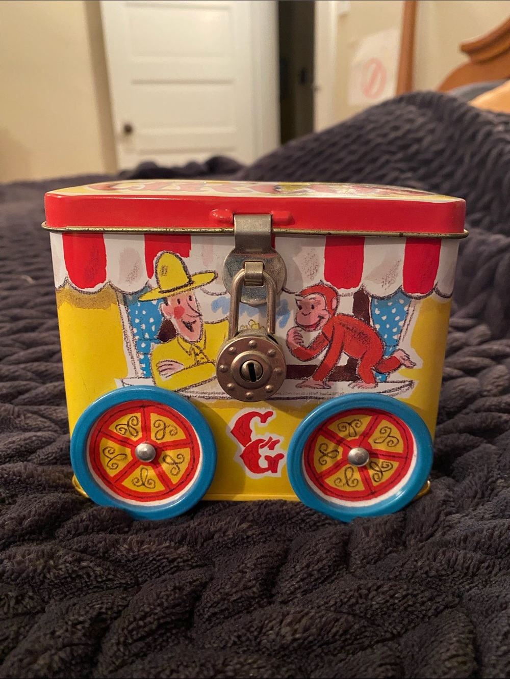Curious George Tin Toy Bank with Padlock & Blue Wheels